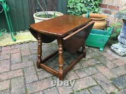 Vintage solid oak oval drop leaf table on ring turned supports coffee table
