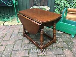 Vintage solid oak oval drop leaf table on ring turned supports coffee table
